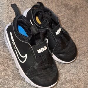 Black and white Nike slip ons